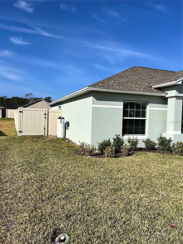 view of property exterior with a lawn