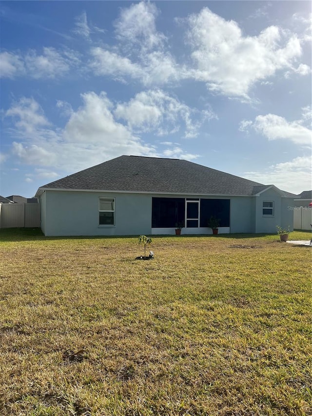 rear view of house with a yard