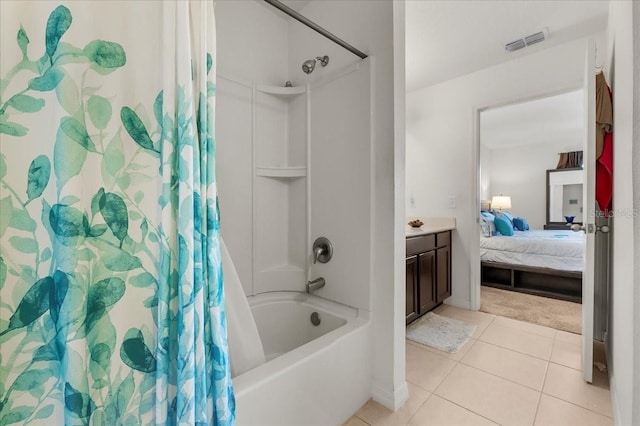 bathroom with tile patterned flooring, vanity, and shower / tub combo