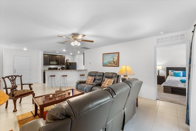 tiled living room with ceiling fan