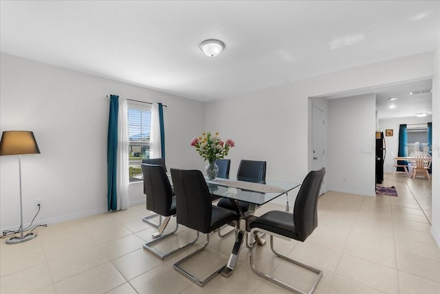 dining area featuring light tile patterned floors