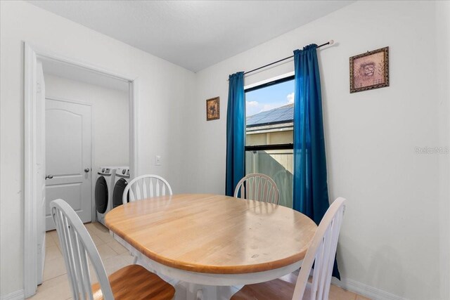 dining area featuring light tile patterned floors and washing machine and clothes dryer