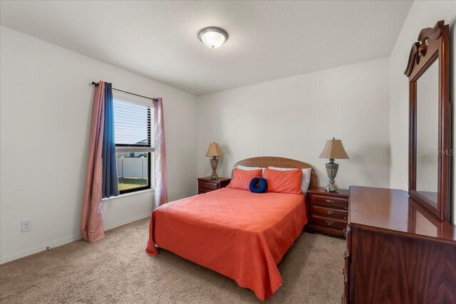 bedroom with light colored carpet