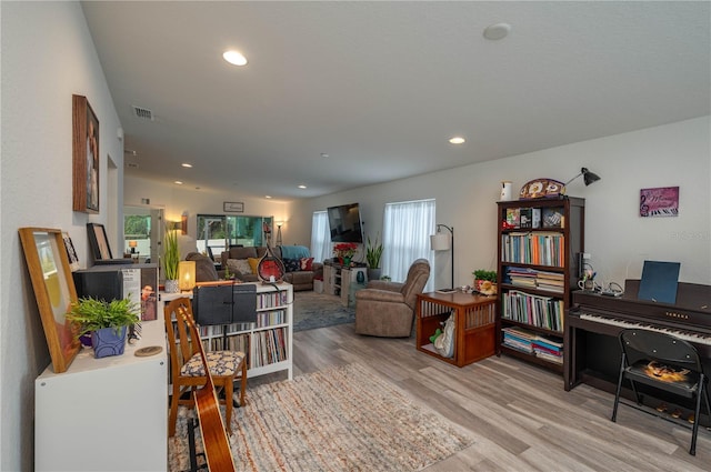 living room with hardwood / wood-style flooring and vaulted ceiling