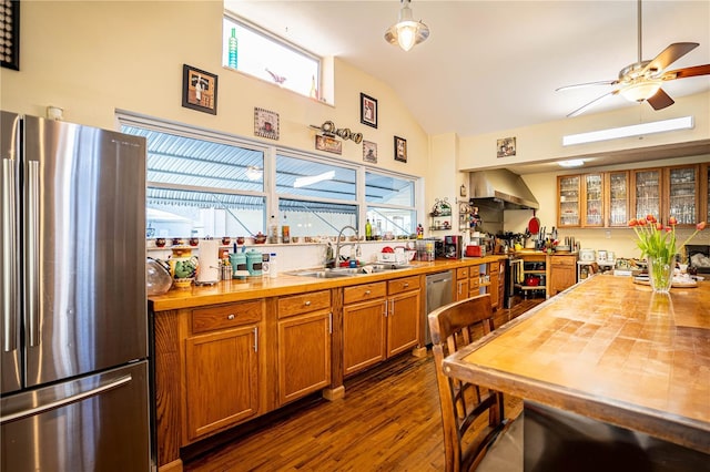 kitchen with sink, butcher block counters, stainless steel appliances, and dark wood-type flooring