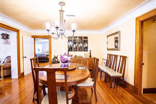 dining space featuring a notable chandelier and light hardwood / wood-style floors