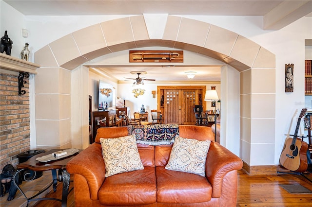 living room with ceiling fan and hardwood / wood-style floors