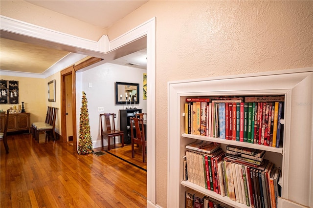 corridor with hardwood / wood-style flooring