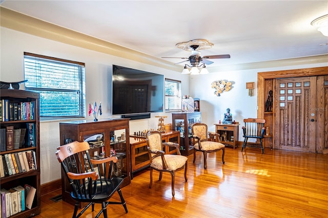 living area featuring ceiling fan and hardwood / wood-style flooring