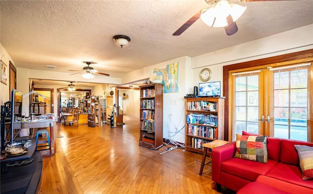 living room with hardwood / wood-style floors and a textured ceiling