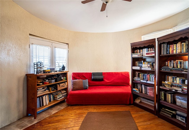 living area with ceiling fan and wood-type flooring