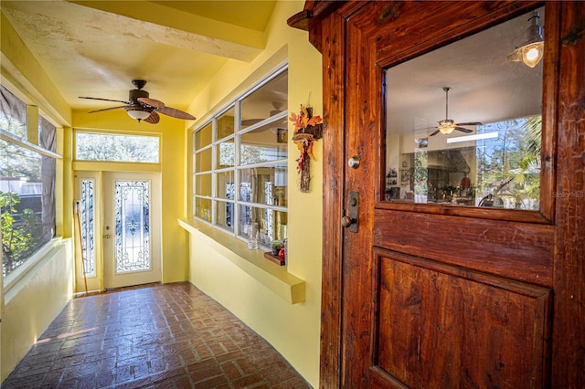 interior space with ceiling fan