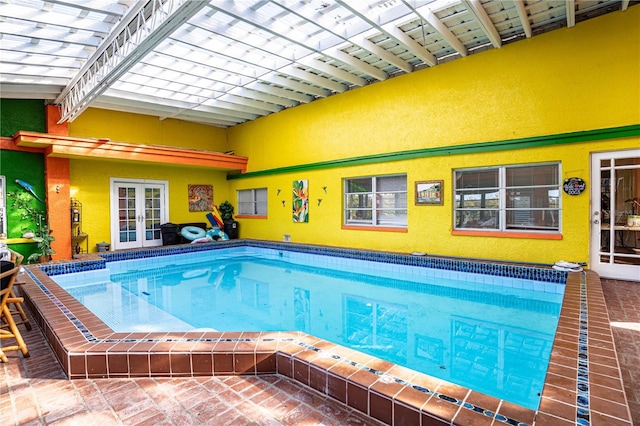 view of swimming pool with french doors