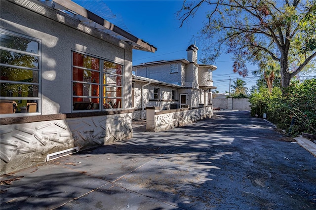 view of side of home with a patio