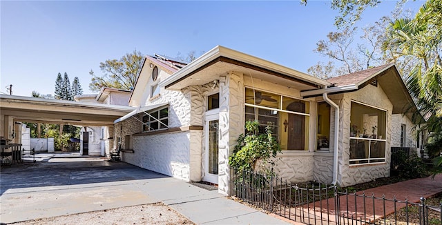 view of side of property featuring a carport