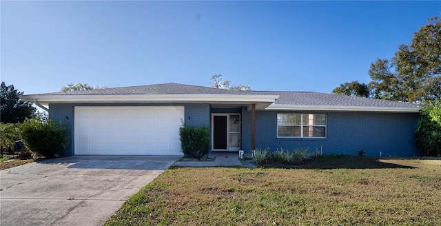 single story home with a garage and a front lawn