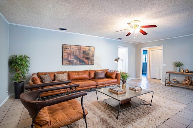 tiled living room with a textured ceiling, ceiling fan, and crown molding