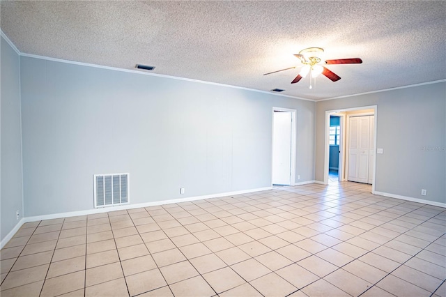 spare room with ceiling fan, light tile patterned flooring, ornamental molding, and a textured ceiling