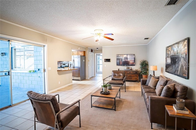 living room with light tile patterned floors, a textured ceiling, and a wealth of natural light