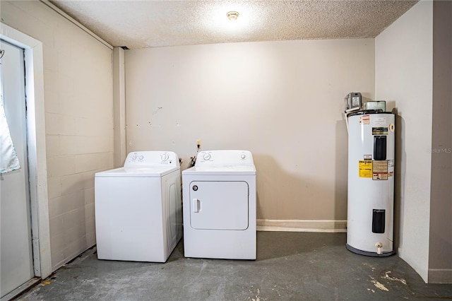 laundry area with washing machine and dryer, electric water heater, and a textured ceiling