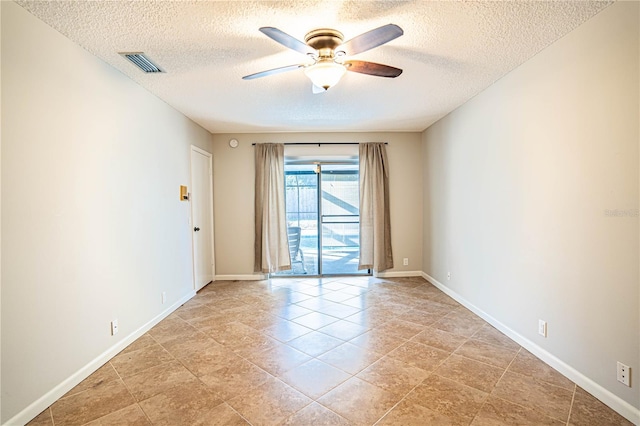 unfurnished room featuring ceiling fan and a textured ceiling