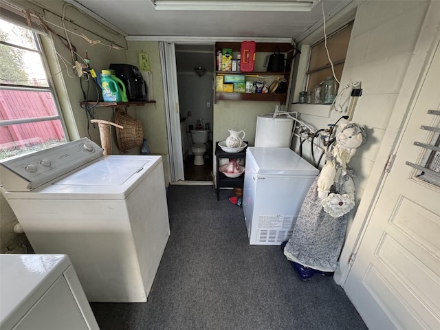 laundry area with dark colored carpet and separate washer and dryer