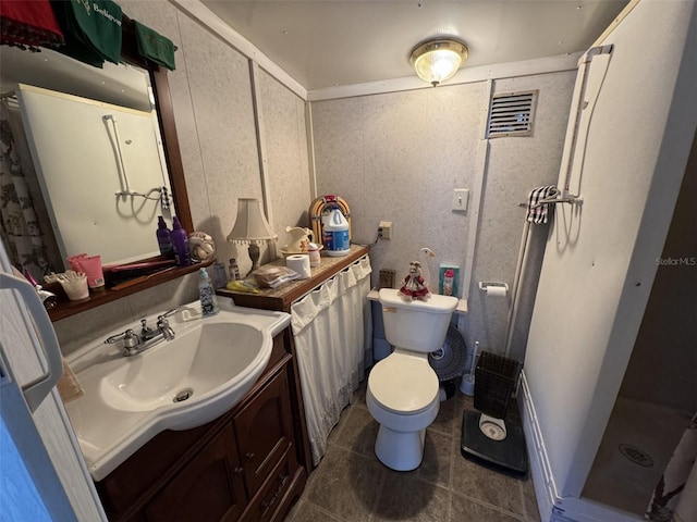 bathroom featuring a shower, tile patterned flooring, vanity, and toilet