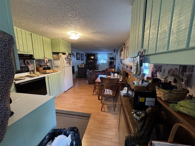 kitchen featuring a textured ceiling, white appliances, light hardwood / wood-style flooring, green cabinetry, and range hood