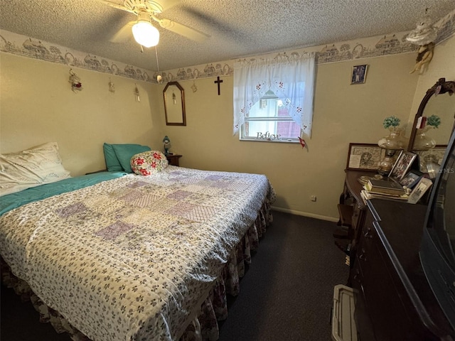 bedroom with ceiling fan, carpet floors, and a textured ceiling