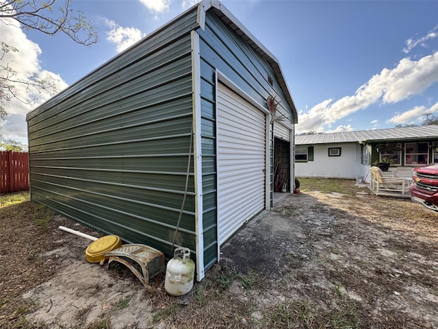 view of side of property with a garage and an outdoor structure