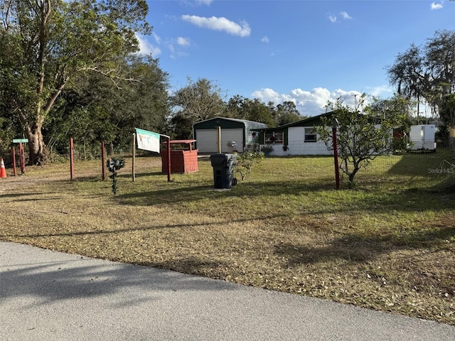 view of yard featuring an outbuilding and a garage