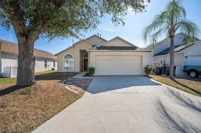 ranch-style house featuring a garage and a front lawn