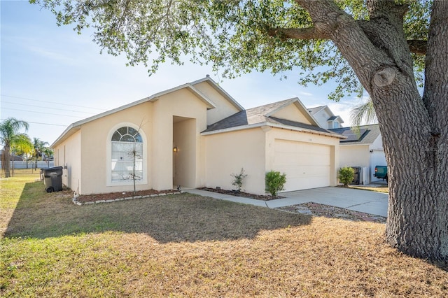 view of front of home with a garage and a front lawn