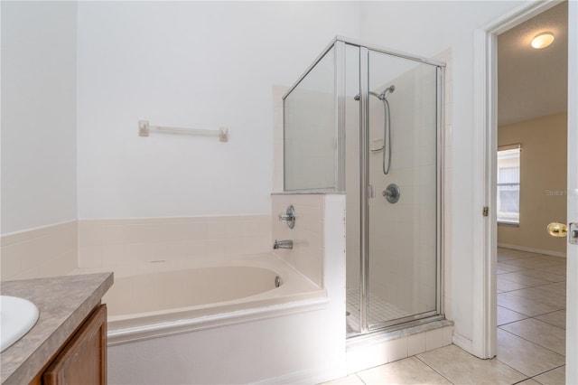 bathroom with tile patterned flooring, vanity, and independent shower and bath