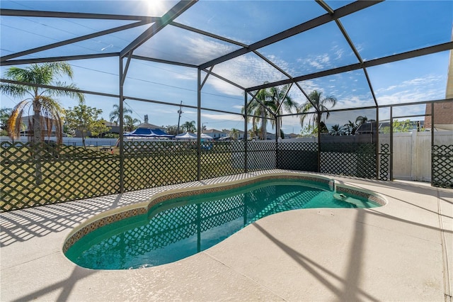 view of swimming pool with a lanai and a patio