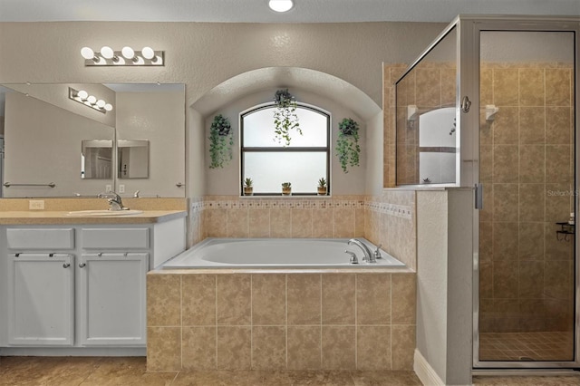 bathroom featuring tile patterned floors, vanity, and separate shower and tub