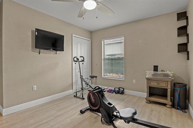 workout area featuring ceiling fan and wood-type flooring