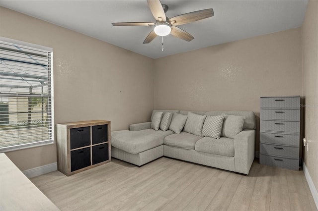 living room with ceiling fan and light wood-type flooring