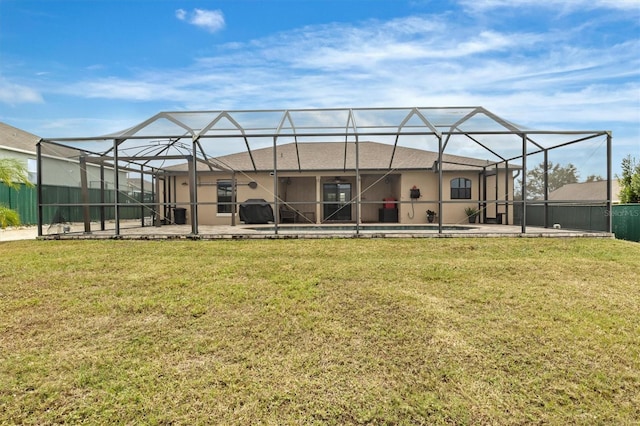 back of house with a lanai and a yard