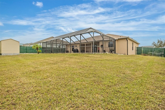 back of property featuring a lawn and glass enclosure