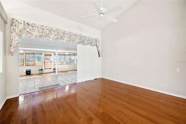 unfurnished living room with ceiling fan, light hardwood / wood-style floors, and vaulted ceiling