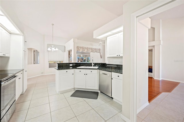 kitchen featuring white cabinetry, stainless steel appliances, kitchen peninsula, decorative light fixtures, and light tile patterned floors