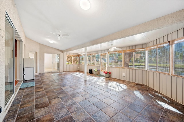 unfurnished sunroom with vaulted ceiling and ceiling fan