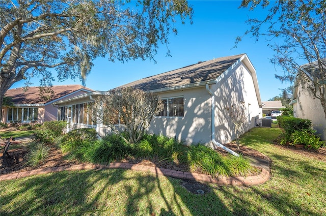 view of side of home featuring a lawn