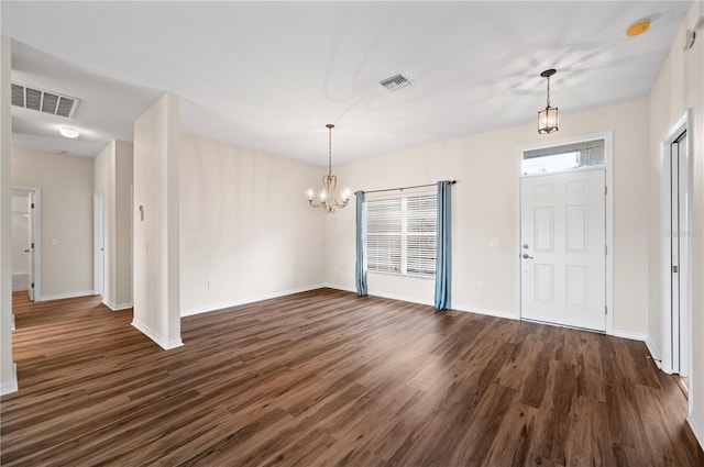 entryway with a chandelier and dark wood-type flooring