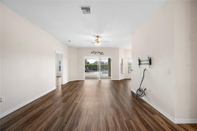 unfurnished living room featuring dark hardwood / wood-style floors and ceiling fan