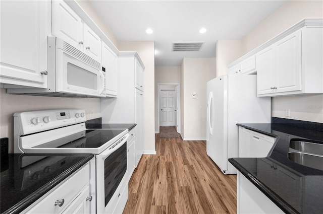 kitchen with white cabinets, white appliances, light hardwood / wood-style floors, and sink