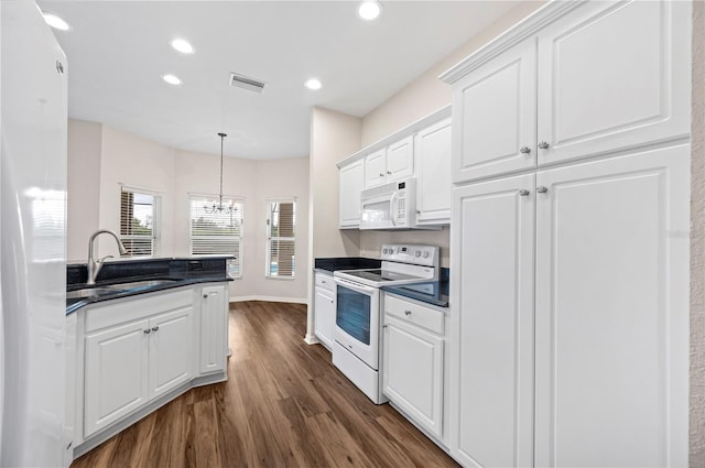 kitchen with white cabinetry, sink, dark wood-type flooring, decorative light fixtures, and white appliances