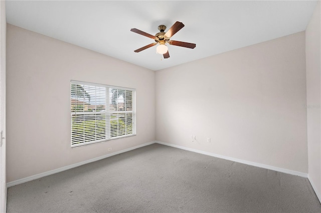 carpeted spare room with ceiling fan