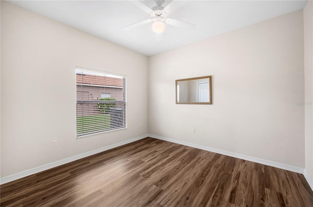 unfurnished room featuring ceiling fan and dark wood-type flooring